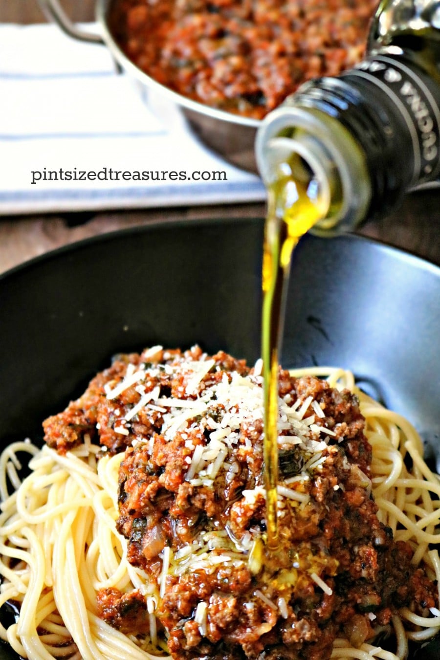pouring olive oil into the bolognese sauce