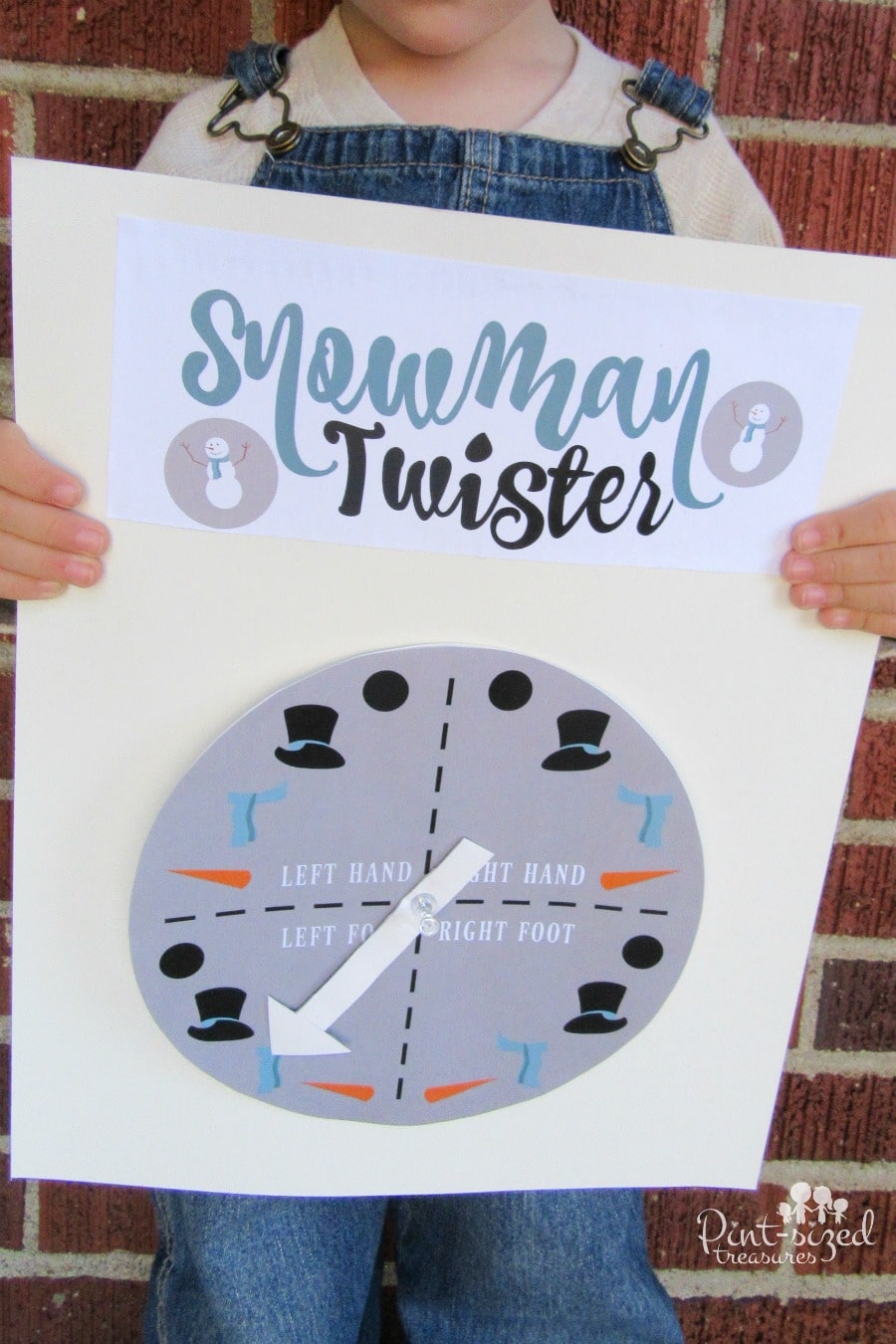 snowman twister printable game being held by a preschooler