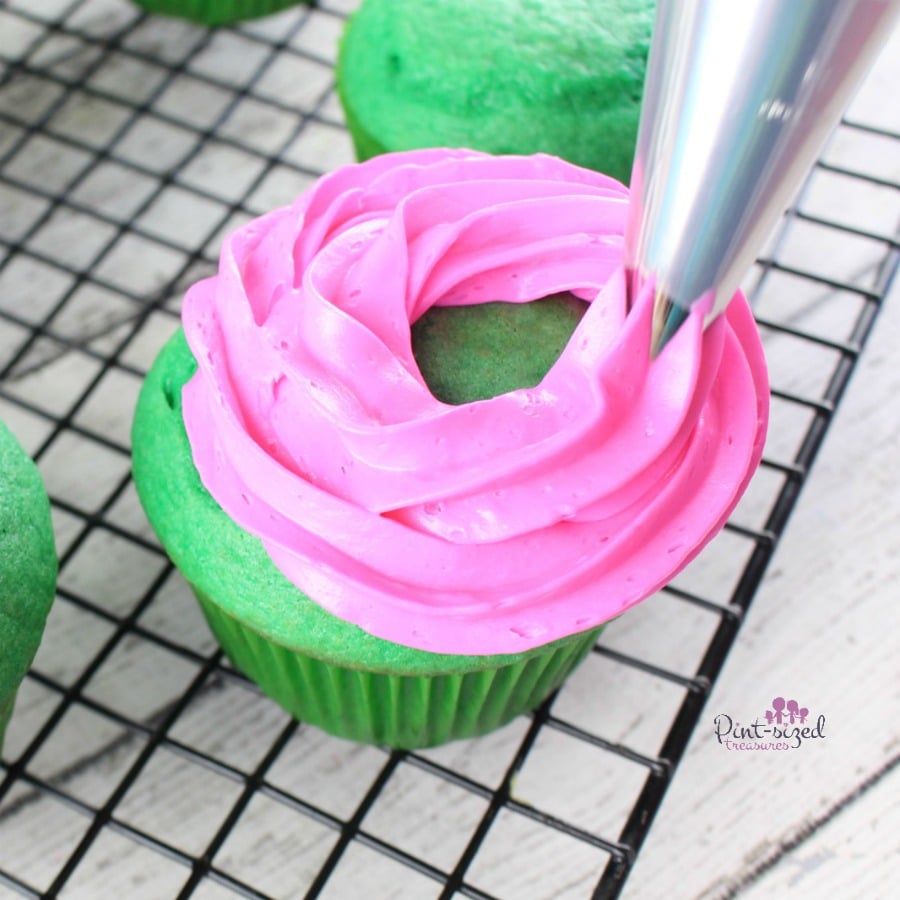 piping frosting onto watermelon cupcakes