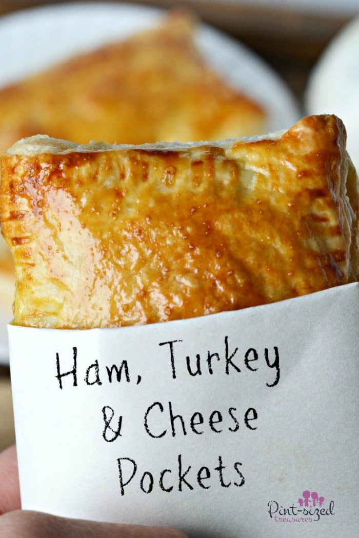Ham, turkey and cheese pockets are a super easy snack or meal that families can keeping the freezer or fridge! We love this homemade version of some convenient foods we enjoyed as kids! #homemadepockets #savorytarts #easyrecipes #hamandcheese #hamandturkey #hamturkeyandcheese #hamsandwich #hotpocket #hamandcheeseturnover #hamandcheesepastry #puffedpastry #recipeswithpuffedpastry #hamandcheesesnack