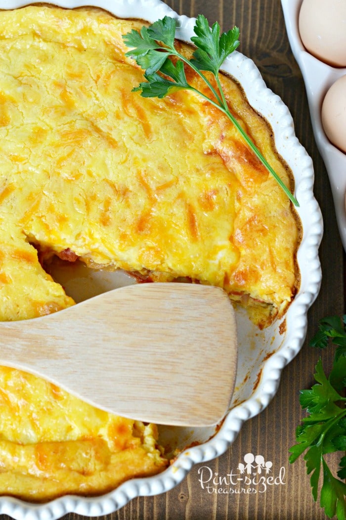 wooden spoon laying on baked crustless quiche