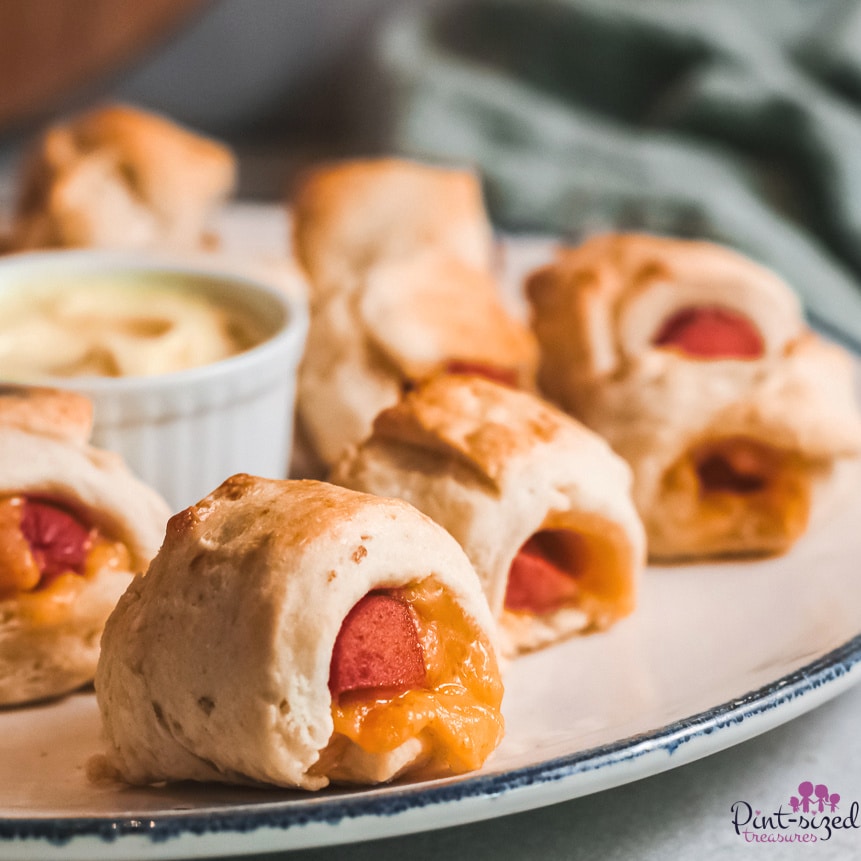 cheese oozing out of pigs in a blanket