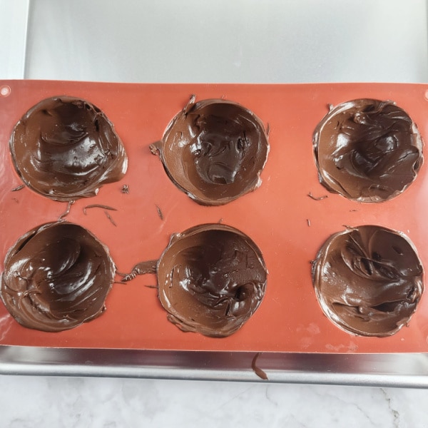 melted chocolate in silicone baking mold for mocha hot chocolate bombs