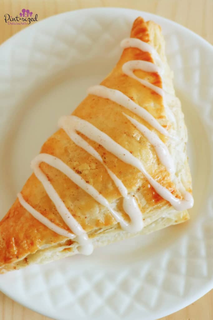 sprinkling the apple turnover with cinnamon