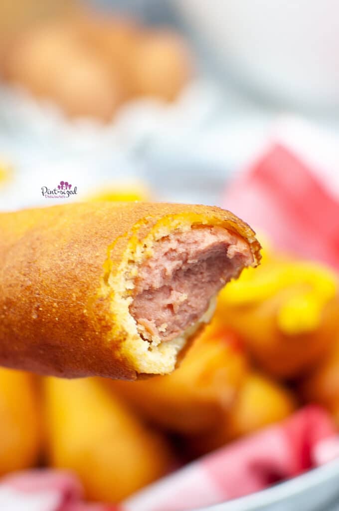 taking a bite of the homemade corn dog