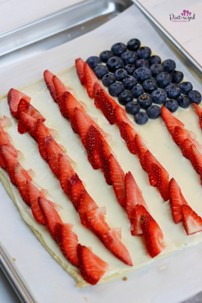 adding blueberries to American flag fruit cookie pizza