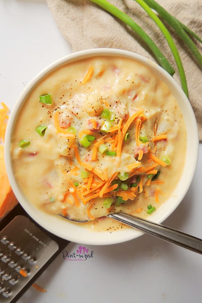loaded potato soup being served in bowl