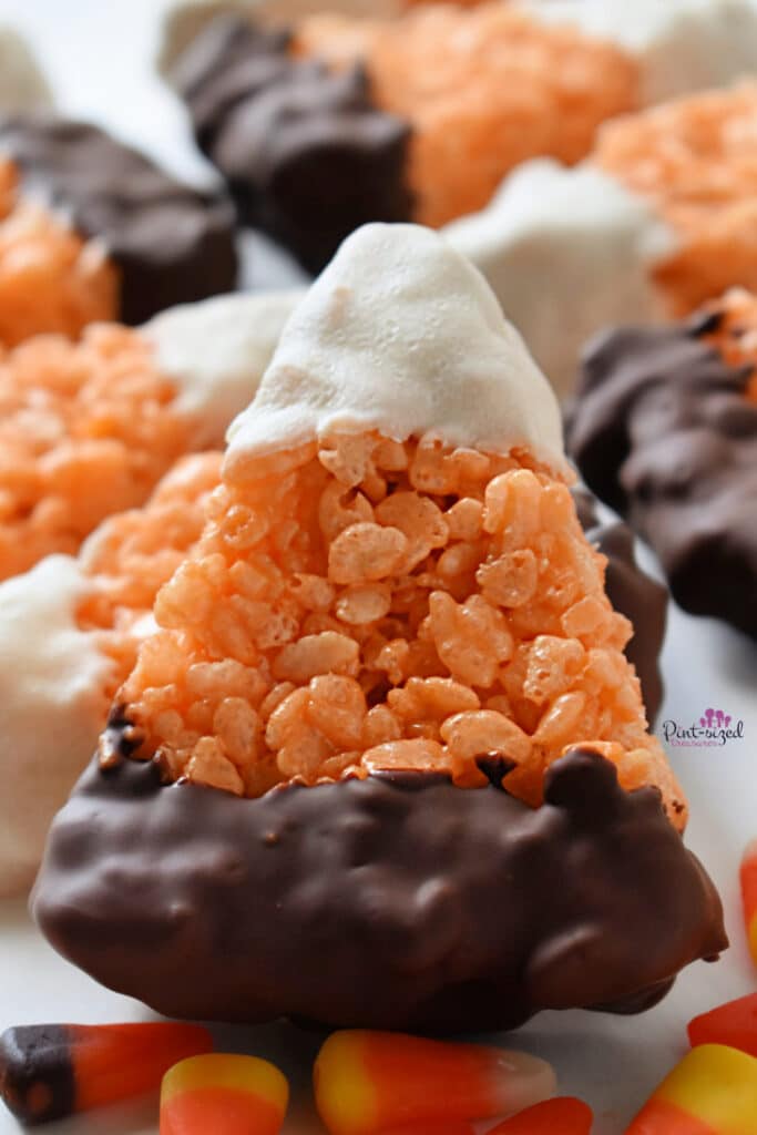 Rice Krispie treats shaped like candy corn and dipped in chocolate