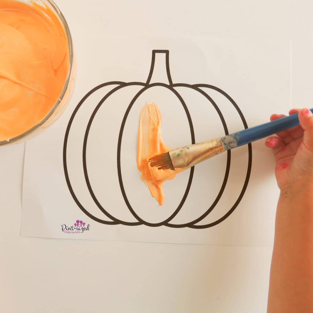 painting the pumpkin with puffy paint