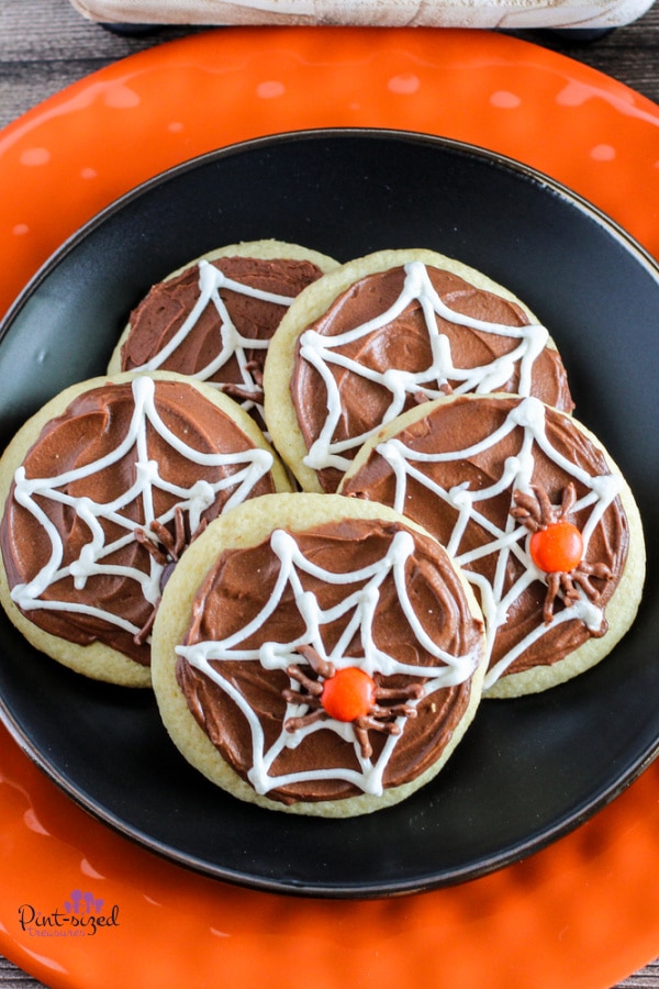 spider web cookies on black plate