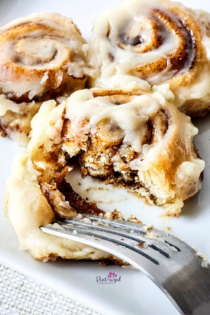 eating a bite of 30 minute cinnamon rolls