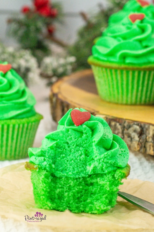 a bite out of a frosted, decorated Grinch cupcake