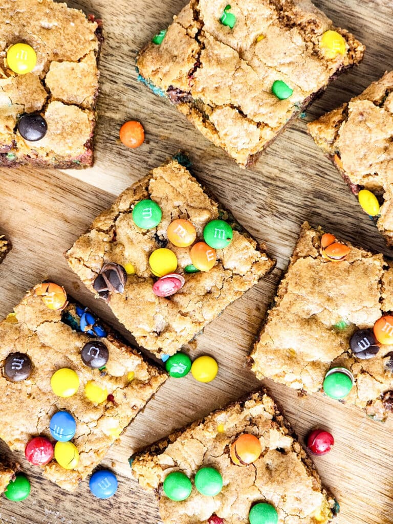 Plate of M&M cookie bars topped with red, green, blue, and yellow candies
