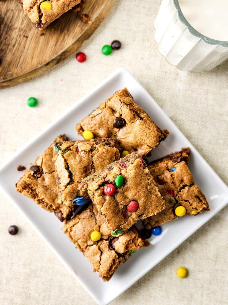 Plate of M&M cookie bars topped with red, green, blue, and yellow candies