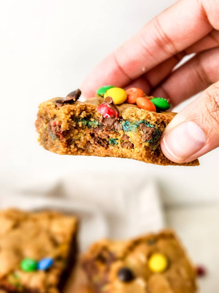 Thick M&M cookie bar with a soft center and candy-coated chocolate pieces