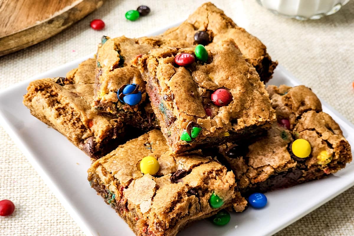 Thick M&M cookie bar with a soft center and candy-coated chocolate pieces