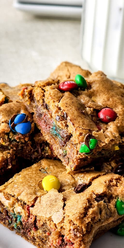 Thick M&M cookie bar with a soft center and candy-coated chocolate pieces