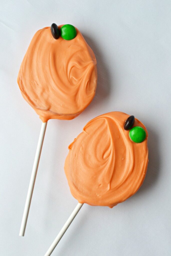 pumpkin pops made from apple slices and chocolate