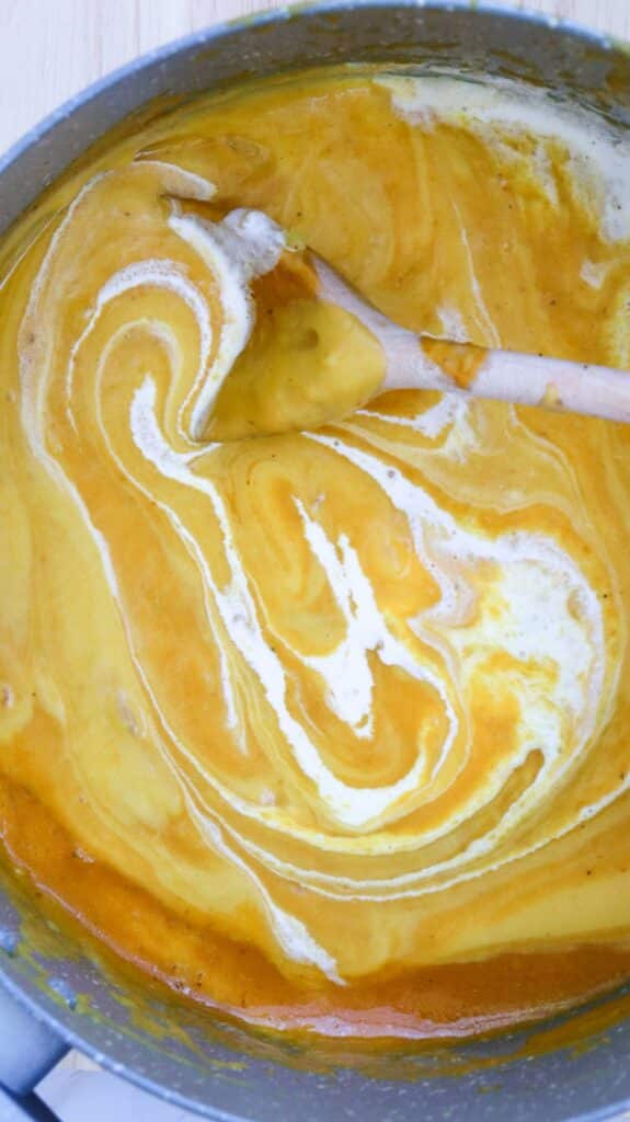 stirring ingredients together for pumpkin soup