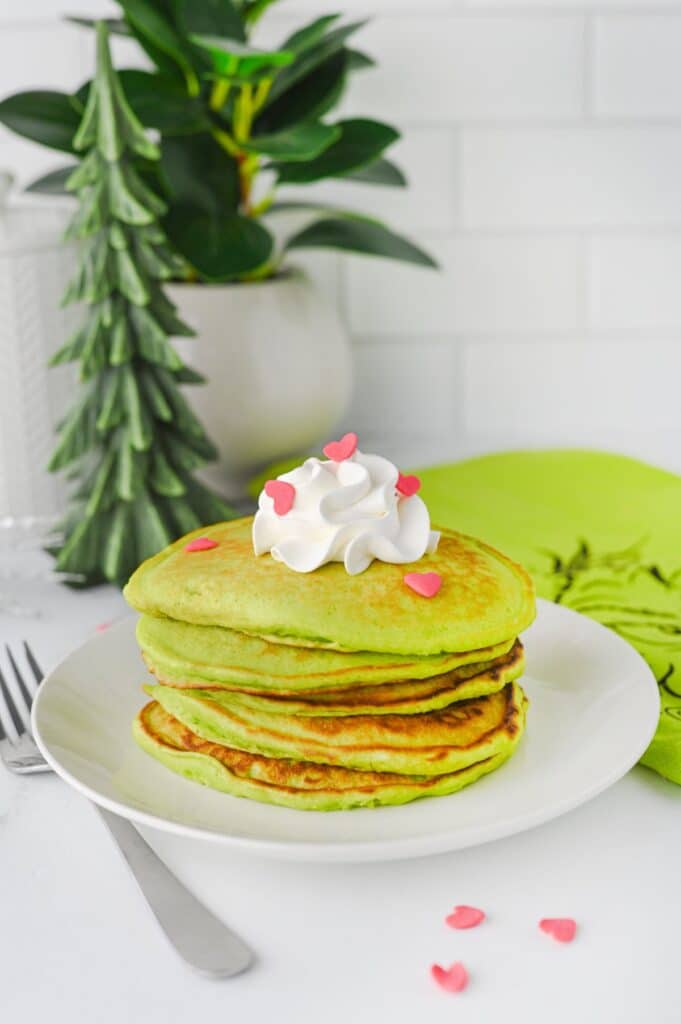 stack of green Grinch pancakes on plate