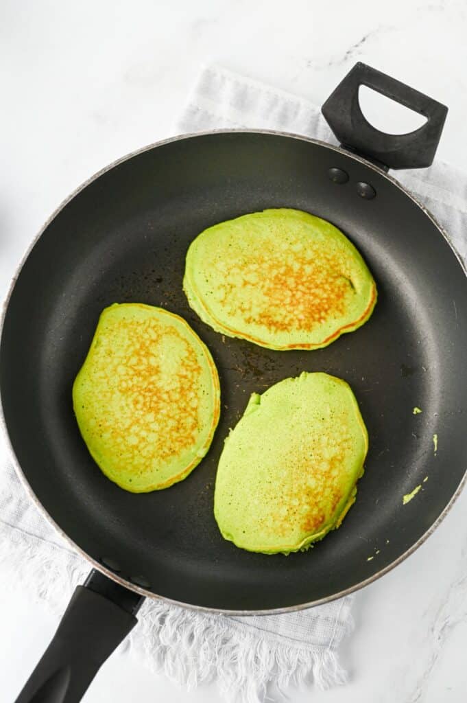 cooking the grinch pancakes in skillet