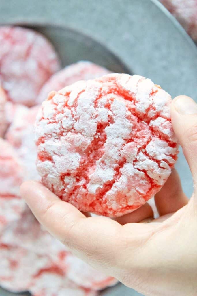 holding strawberry crinkle cookie